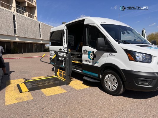 HealthLift Arizona Wheelchair Accessible Van With a Heavy-Duty Hydraulic Lift Deployed on the Pavement For Safe Boarding