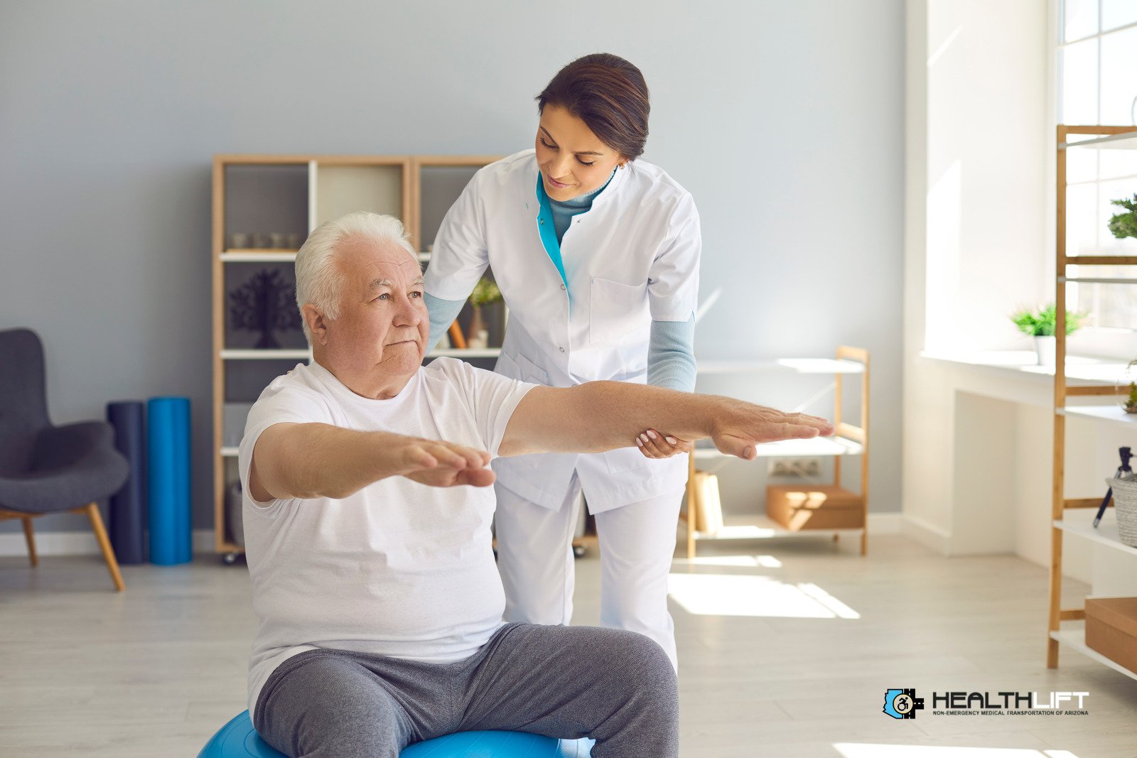 Female physiotherapist trains senior man in room supporting his outstretched arms. Therapist Helping Senior Patient With Arm Exercises