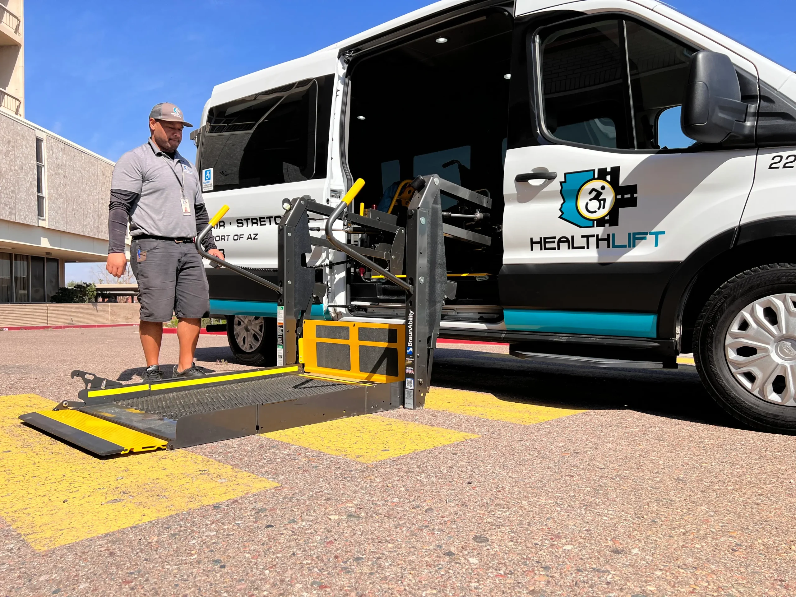 driver-accessible-van-wheelchair-lift Driver Beside Accessible Van with Wheelchair Lift